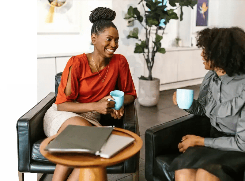 Two colleagues chatting over coffee