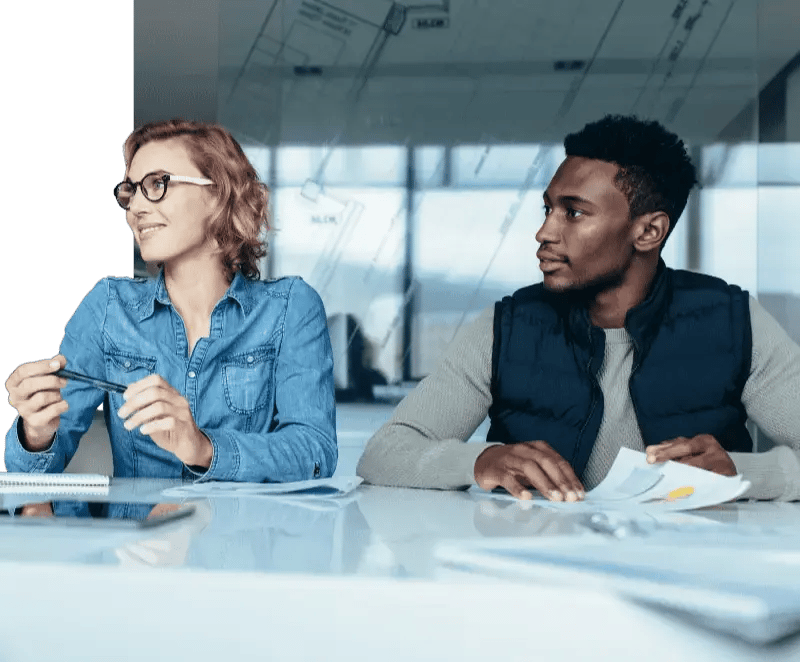 Two colleagues sitting and watching a presentation