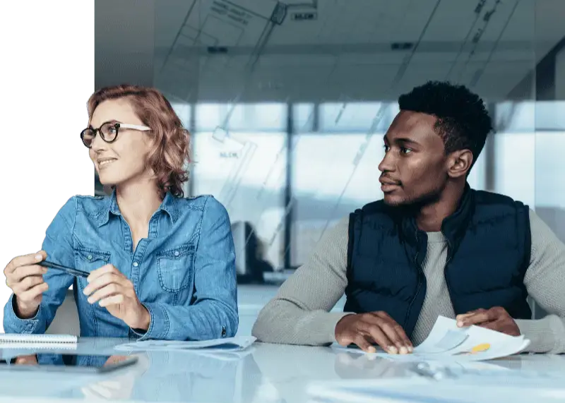 Two colleagues are sitting and watching a presentation