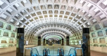 Washington Metro station with vaulted concrete ceiling, escalators, and geometric architectural design.