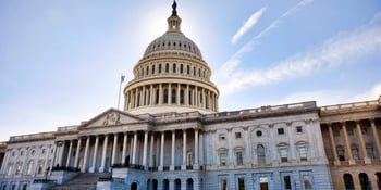 The United States Capitol building under a clear blue sky.